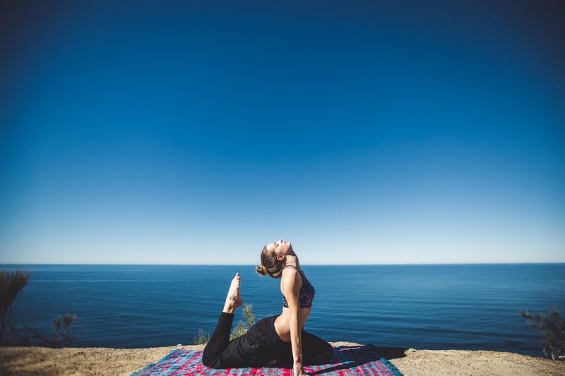 Woman practicing Yin Yoga at sunset